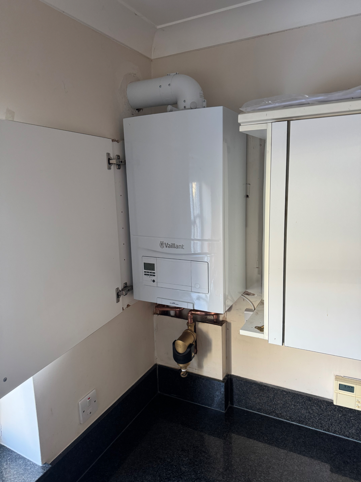 Vaillant ecoFIT pure boiler installed inside a kitchen cupboard, ready for its annual service